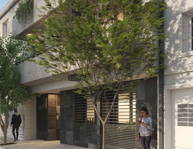 Vereda arbolada frente al edificio ZAINO, con el acceso principal