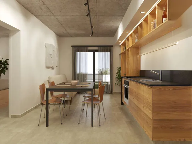 Cocina comedor integrada con muebles de madera y cielorraso de hormigón a la vista